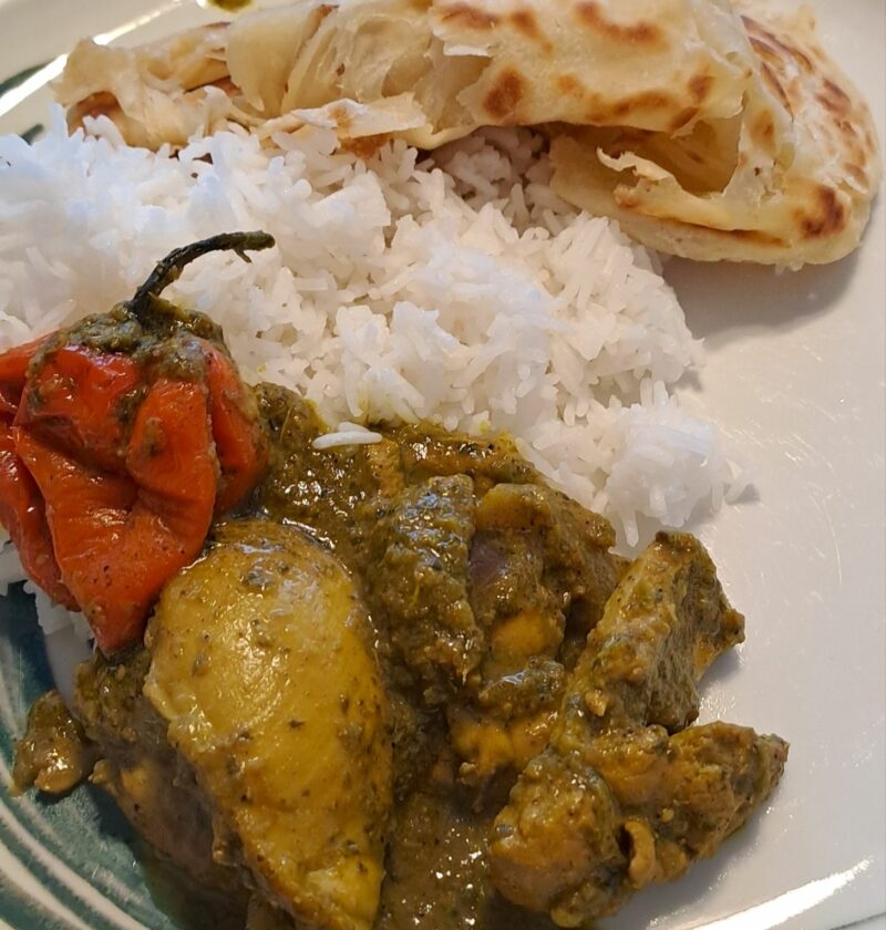 Trini curry chicken with rice and Buss Up Shut