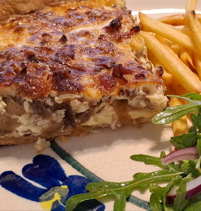 Cheesy quiche Lorraine with salad and chips