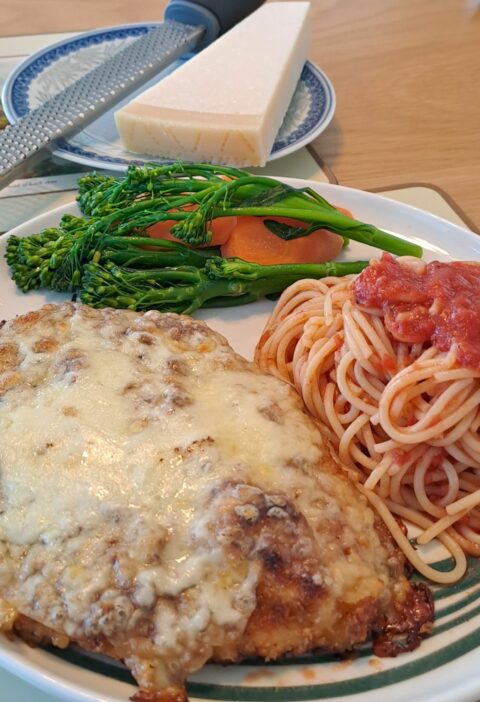 Chicken parm with tomato sauce spaghetti and buttered vegetables