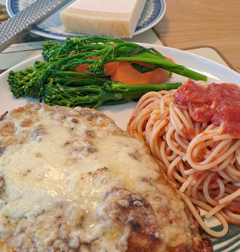 Chicken parm with tomato sauce spaghetti and buttered vegetables